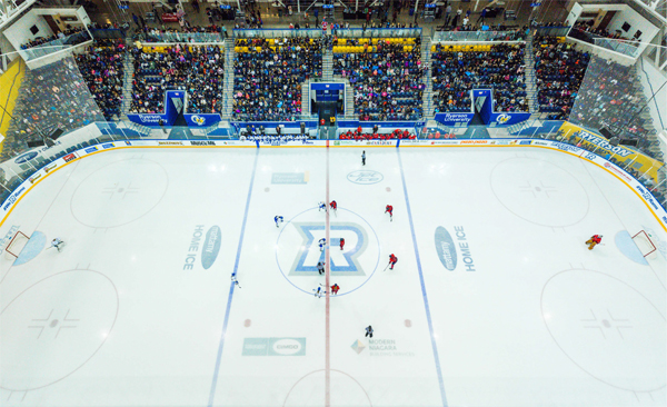 Image of hockey players and the crowd at the MAC hockey rink
