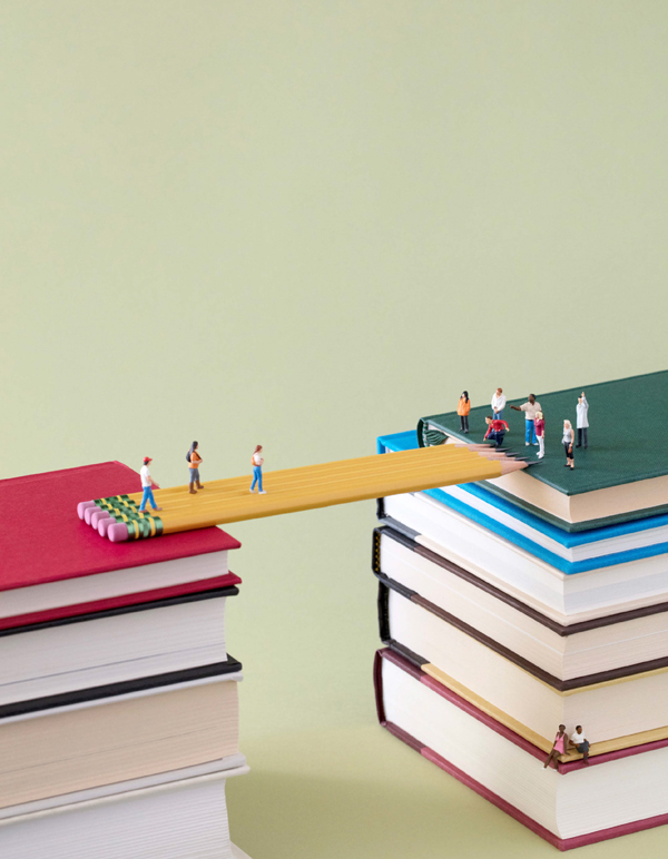 Image of small figures crossing a bridge made of pencils
