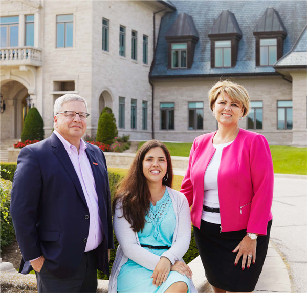 King alumni Marc Neeb and Nadia Gomes Bento with King Principal Maria May at Magna headquarters.